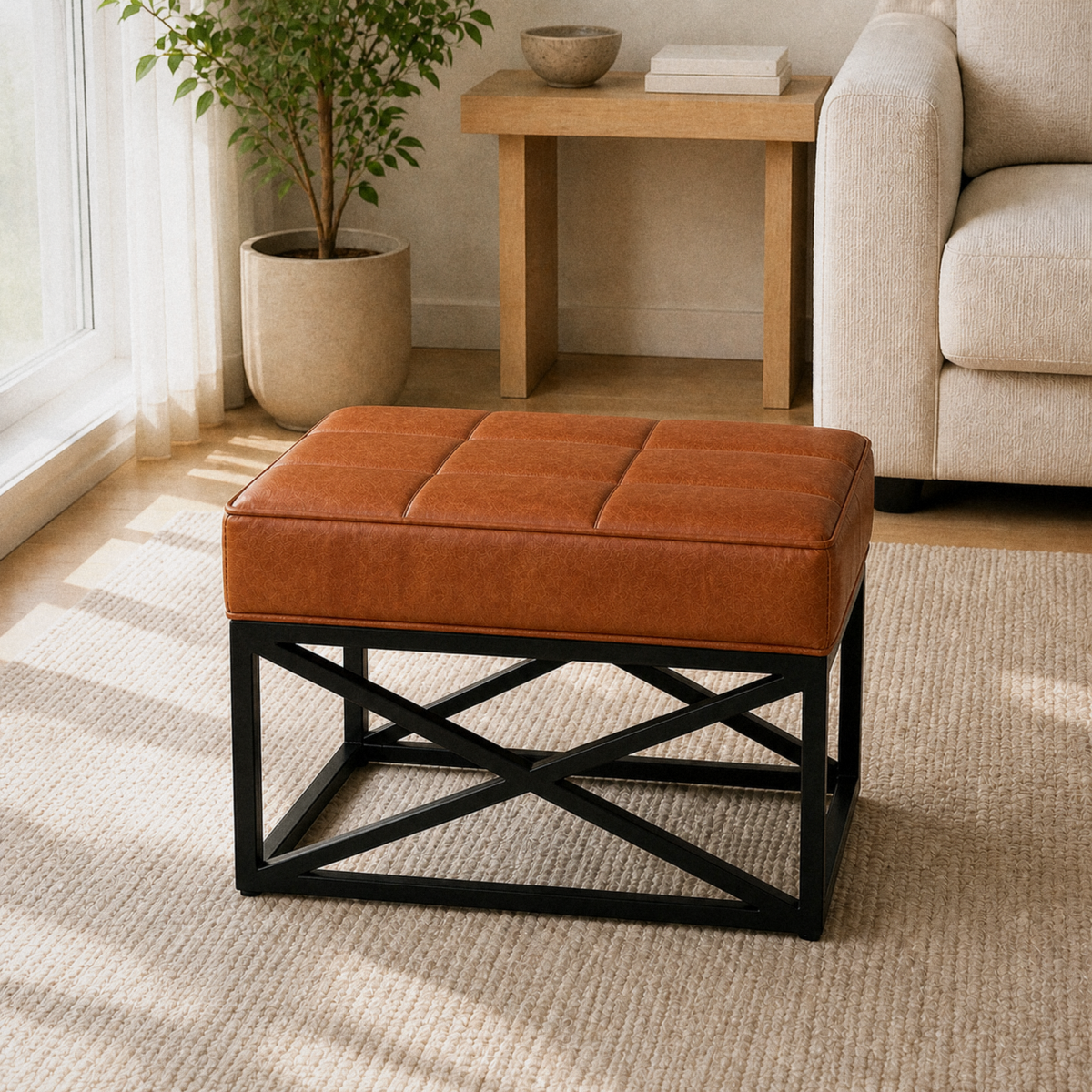 Oak living room | saddle tan leather ottoman with a four-by-three stitched top and black X-base on a plain oatmeal rug