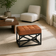 Sage living room | saddle tan leather ottoman with twelve stitched top panels on a plain rug