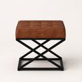 Front | saddle tan top-grain leather ottoman with twelve stitched top panels and black square-tube X-base