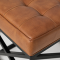 Leather detail | close view of saddle tan top-grain leather grain, stitched seams, and rounded piping