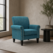 Loft living room | blue-green tweed nailhead armchair beside a black steel side table