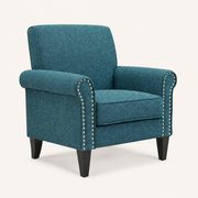 Studio three-quarter | blue-green tweed armchair showing the rolled arm, curved nailhead trim, and tapered legs