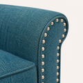 Tweed close-up | blue-green woven tweed on the rolled arm beside silver-toned nailheads