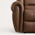 Detail | close view of a rolled recliner arm with antique brass nailhead trim