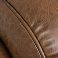 Texture | close view of Nut Brown embossed faux leather and a piped seam