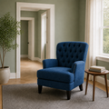 Scale | navy blue tufted chair beside a full-height doorway in a sage green room for scale