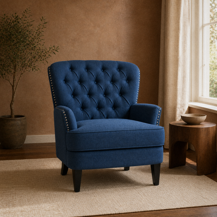 In a room | navy blue tufted accent chair on a cream rug in a terracotta-toned room with a walnut side table