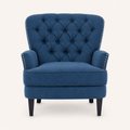 Front | straight-on studio view of the dark-blue upholstered chair with diamond tufted back and silver nailhead trim