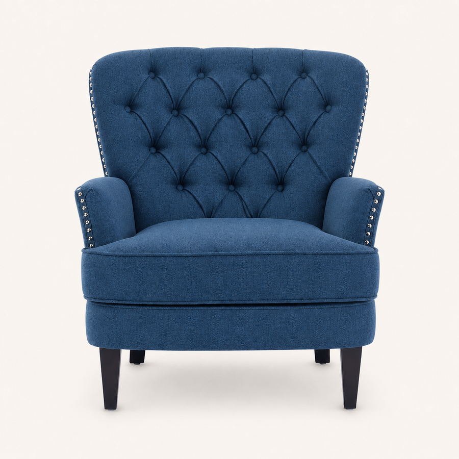 Front | straight-on studio view of the dark-blue upholstered chair with diamond tufted back and silver nailhead trim