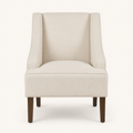 Studio front | cream upholstered swoop-arm chair with curved piped arms and four brown tapered legs
