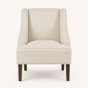 Studio front | cream upholstered swoop-arm chair with curved piped arms and four brown tapered legs