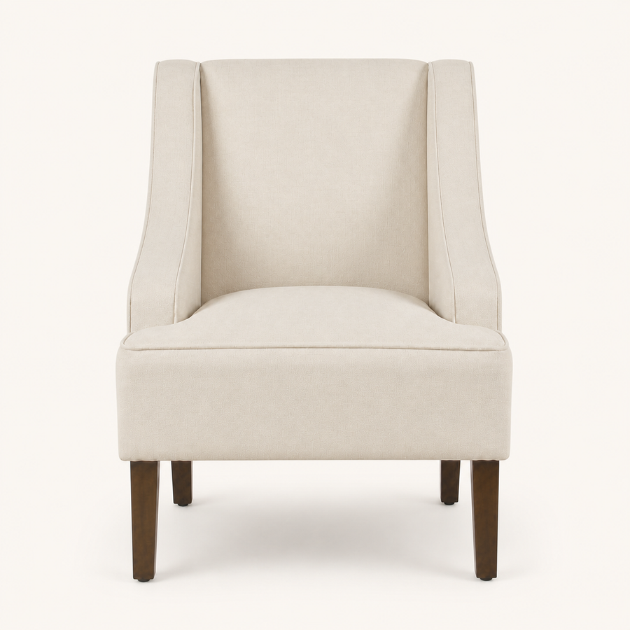 Studio front | cream upholstered swoop-arm chair with curved piped arms and four brown tapered legs