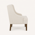 Studio side | side and rear profile of the cream chair, showing the tall back and leg placement
