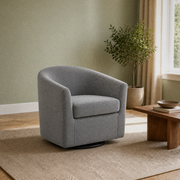 Angle | three-quarter sage green living room view of the slate gray swivel barrel chair with its curved back, side seam, and black swivel base