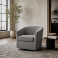 In a room | greige loft living room with the slate gray swivel barrel chair beside a black side table and tall window