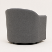 Side | rear-side studio view of the slate gray swivel barrel chair showing the curved rear shell, seams, and low black circular swivel base
