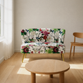 In a room | floral armless loveseat with gold tapered legs in a bright warm-white living room