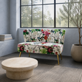 In a room | floral armless loveseat in a cool blue-gray sunroom with a black steel window wall