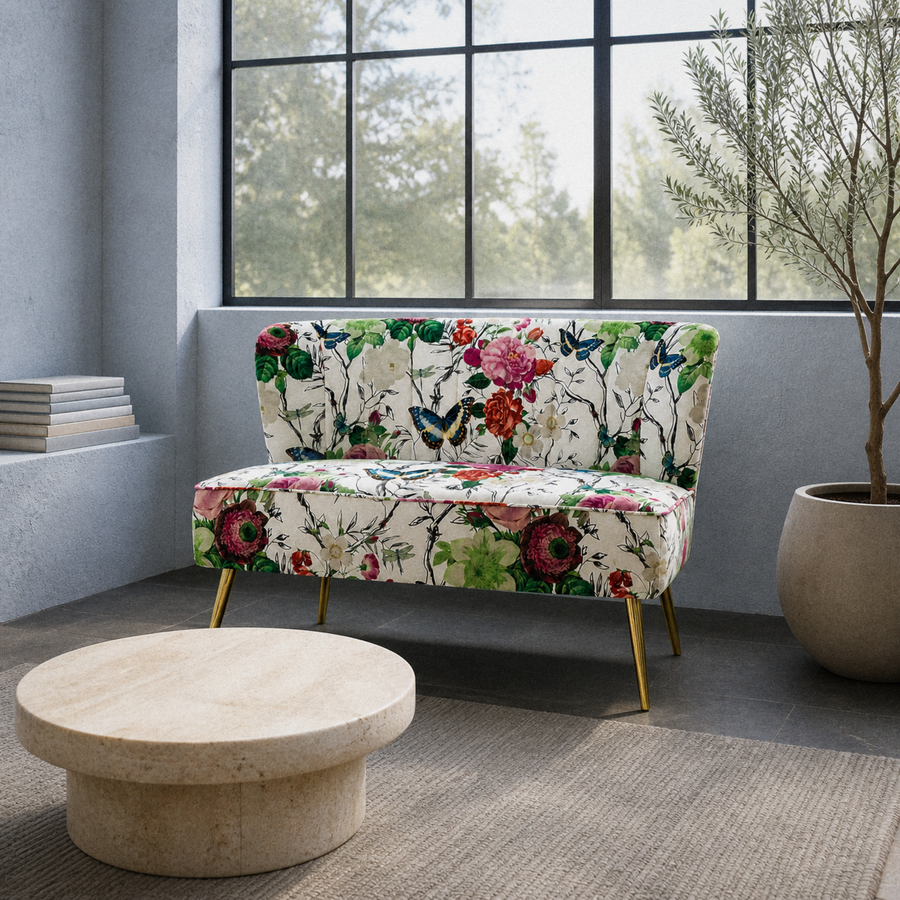 In a room | floral armless loveseat in a cool blue-gray sunroom with a black steel window wall
