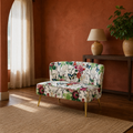 In a room | floral armless loveseat in a terracotta reading room with a dark walnut floor