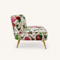 Side | right-side studio profile of the floral armless loveseat showing its curved back and gold legs