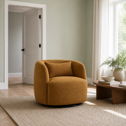 In scale | amber-gold brown boucle swivel armchair beside an uncropped full-height interior doorway