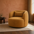 In a room | amber-gold brown boucle swivel armchair in a clay-toned living room with dark walnut flooring