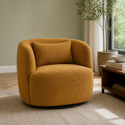 In a room | amber-gold brown boucle swivel armchair in a soft sage living room with light ash flooring