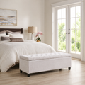 Scale | Ivory storage bench beside full-height French doors in a bedroom with a light wood floor
