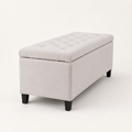 Side | Ivory storage bench from a side angle showing the upholstered end, long side panel, tufted lid depth, and dark wood feet