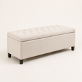 Three-quarter | Ivory button-tufted storage bench from the front-left on a clean studio ground, showing the upholstered end and dark wood feet
