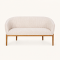Front | straight-on studio view of the beige channel-back loveseat with brown wood legs