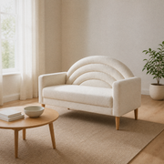 Warm living room angle | Right three-quarter view of the cream textured loveseat with a pale wood coffee table, rug, and window
