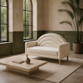 Green millwork room | Cream textured loveseat with an arched channel back in a room with moss-green millwork, arched windows, and a stone floor
