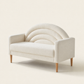 Three-quarter studio | Cream textured loveseat from the right, showing the square arm depth, one bench seat, arched back channels, and tapered brown legs
