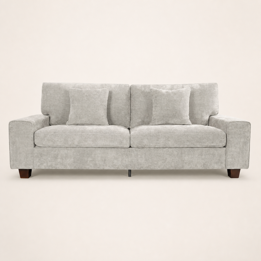 Studio | Straight-on view of the beige-gray chenille sofa with square arms, two pillows, and brown wood legs