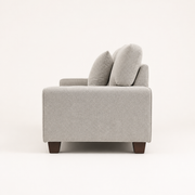 Studio | Right-side profile of the compact sofa showing arm depth, straight back, and brown wood legs