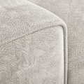 Detail | Close view of beige-gray nubby chenille upholstery and a cushion-edge seam
