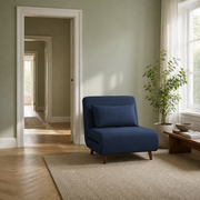 In scale | navy blue armless convertible chair beside an uncropped full-height interior doorway