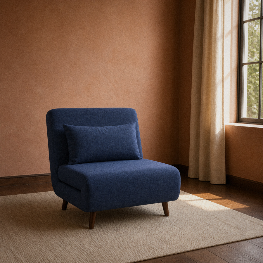 Room 2 | navy blue armless convertible chair on a plain oatmeal rug in a muted terracotta room with a dark wood floor