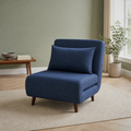 Room 3 | navy blue armless convertible chair on a plain oatmeal rug in a sage room with a light wood floor and window at right