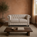 Room | Beige linen blend Chesterfield loveseat with rolled nailhead arms in a clay-toned living room