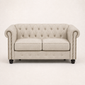 Front | Beige linen blend Chesterfield loveseat with two seat cushions, rolled nailhead arms, a tufted back, and black turned wood legs