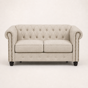 Front | Beige linen blend Chesterfield loveseat with two seat cushions, rolled nailhead arms, a tufted back, and black turned wood legs
