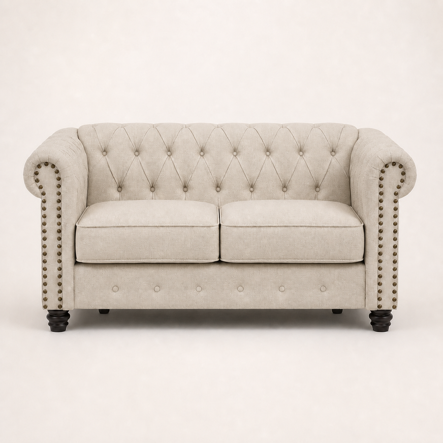 Front | Beige linen blend Chesterfield loveseat with two seat cushions, rolled nailhead arms, a tufted back, and black turned wood legs