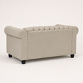 Studio | Rear-side profile of the beige linen blend loveseat showing the plain upholstered back, rolled arm, and black turned legs