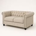 Studio | Front-right three-quarter view of the beige linen blend loveseat with two cushions, tufted back, and bronze nailhead trim