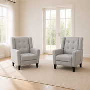 In scale | two light gray armchairs beside a full-height doorway in a warm white room