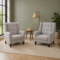 Sage room | two matching light gray armchairs in a sage green living room with a left window