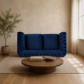 Room | Navy-blue velvet button-tufted rolled-arm loveseat in a warm sand living room with a walnut coffee table and oatmeal rug